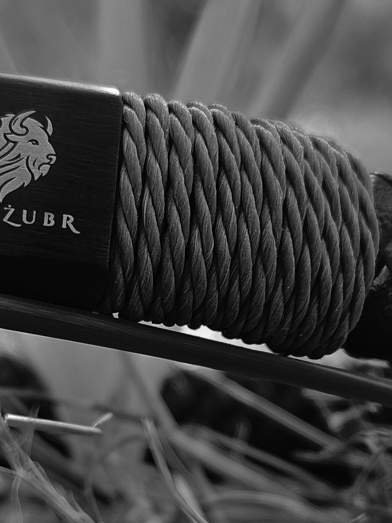 Close-up of a TOROZUBR brand product with rope and metal elements.